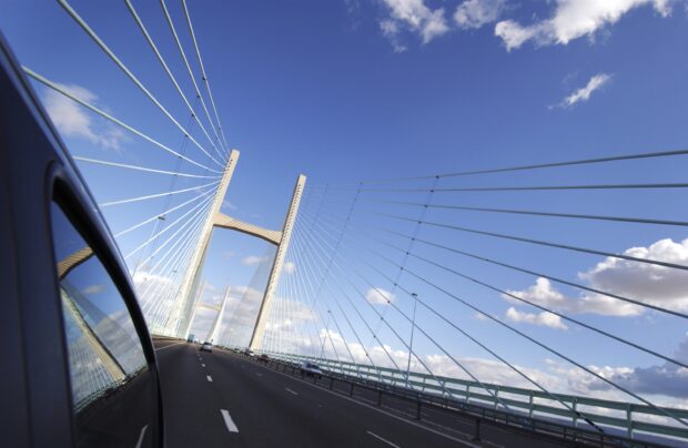 The Second Severn Crossing, Bristol. Long shot of suspension bridge alongside vehicle.